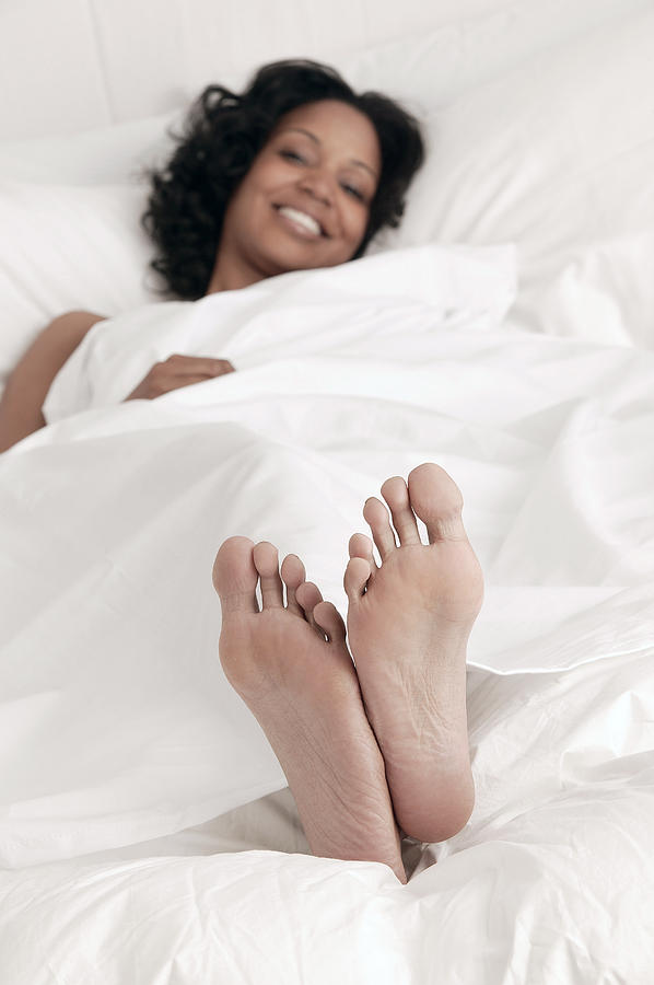 Woman lying in bed Photograph by Comstock Images