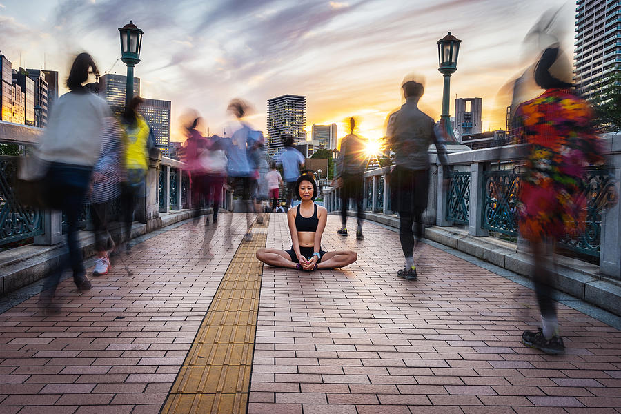 Woman Meditating Into The Crowd At Sunset Photograph by FilippoBacci
