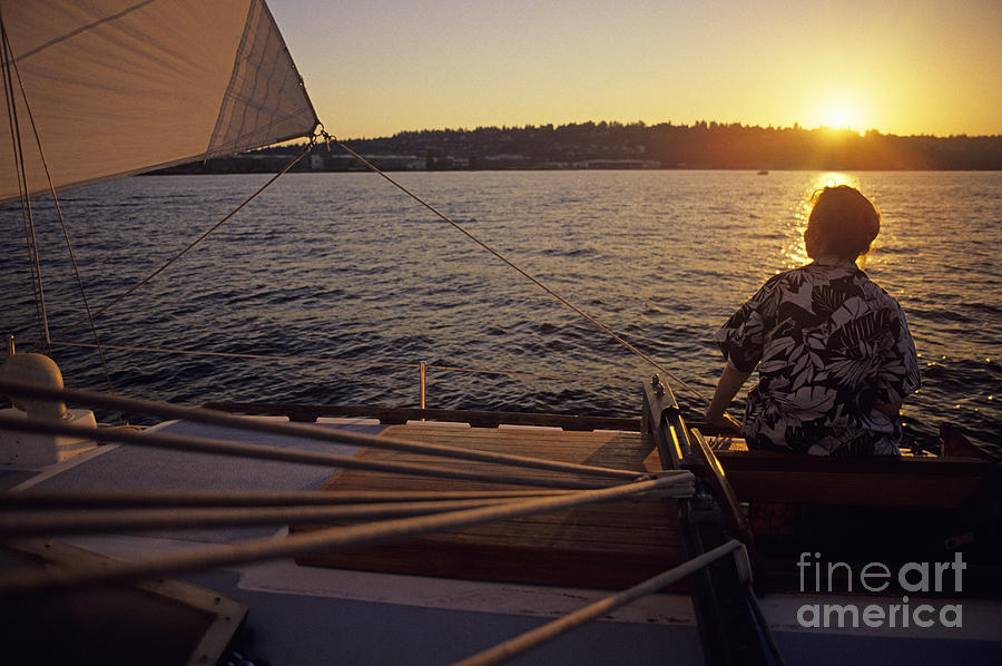Woman on sailboat sunset Photograph by Jim Corwin