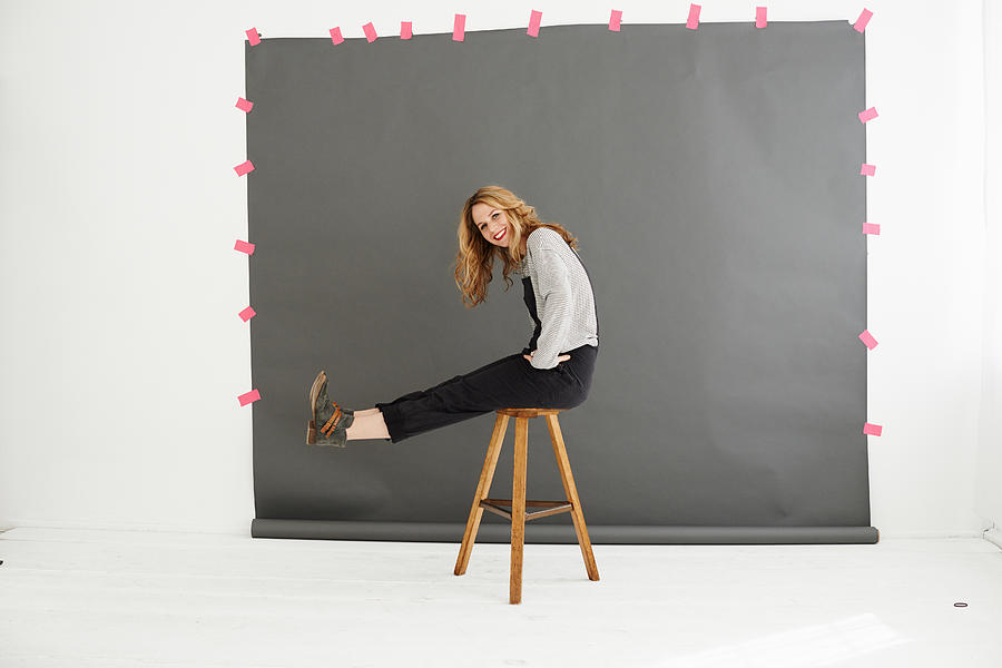 Woman on stool in front of photographers backdrop Photograph by Conny Marshaus