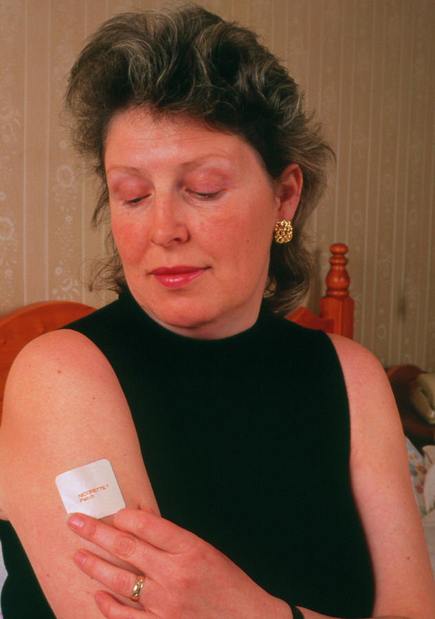 Woman Placing Nicotine Patch On Arm Photograph by Jim Selby/science Photo Library