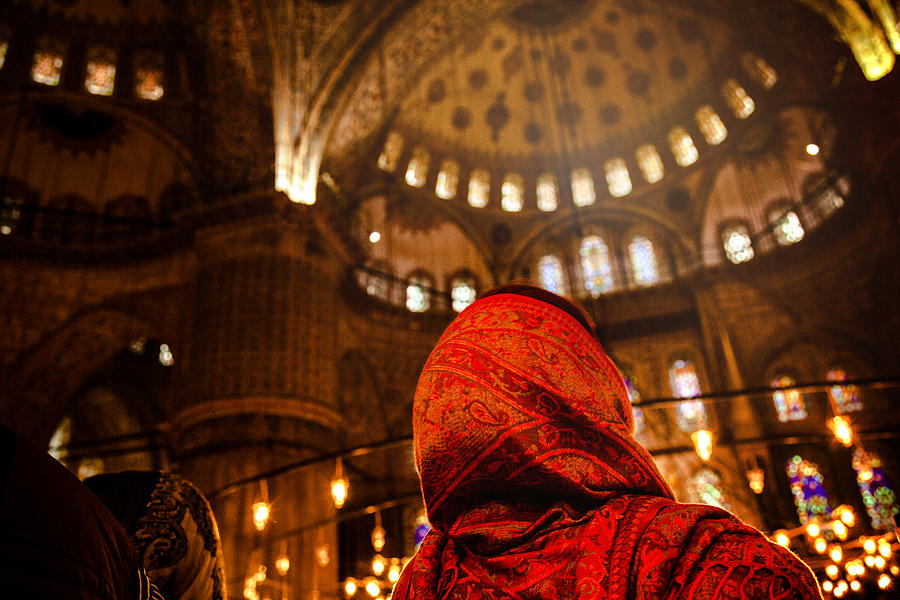 Woman praying inside a mosque Photograph by LeoPatrizi