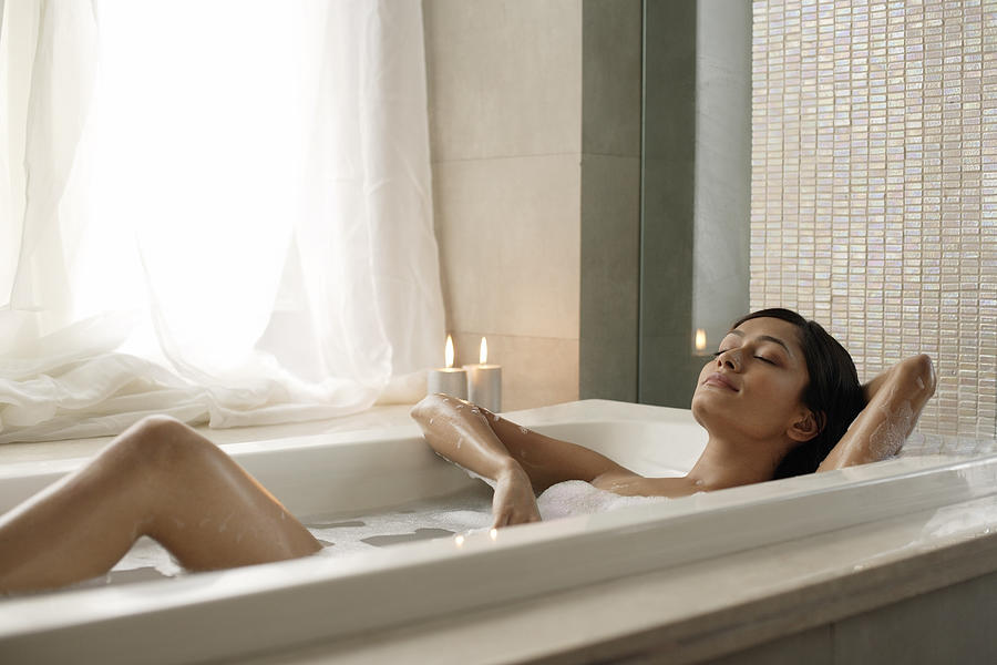 Woman reclining in bathtub Photograph by Asia_Images