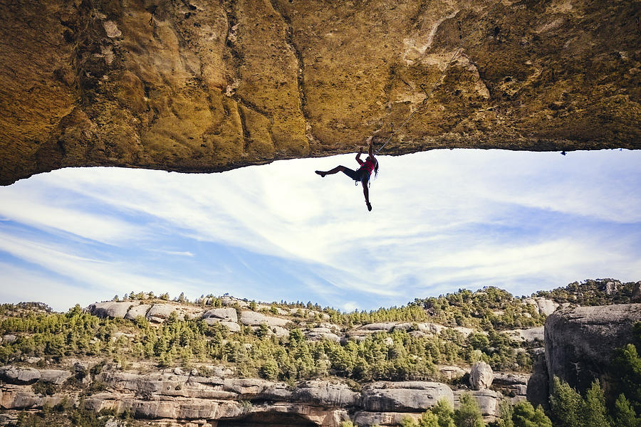 Woman rock climbing Photograph by Aluxum