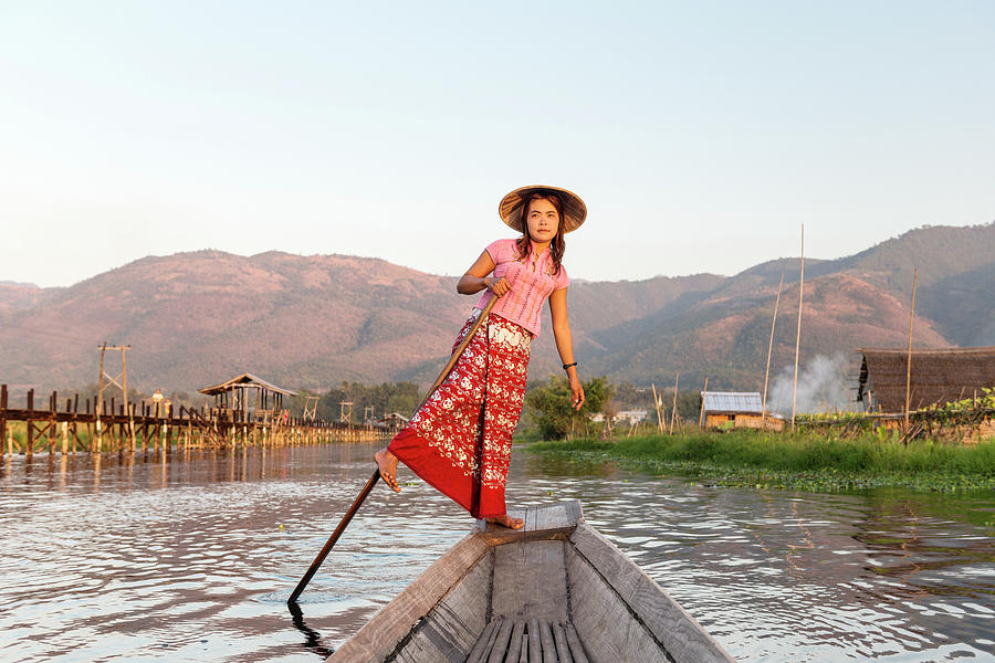 Woman Rowing Boat Through Floating Photograph by Martin Puddy