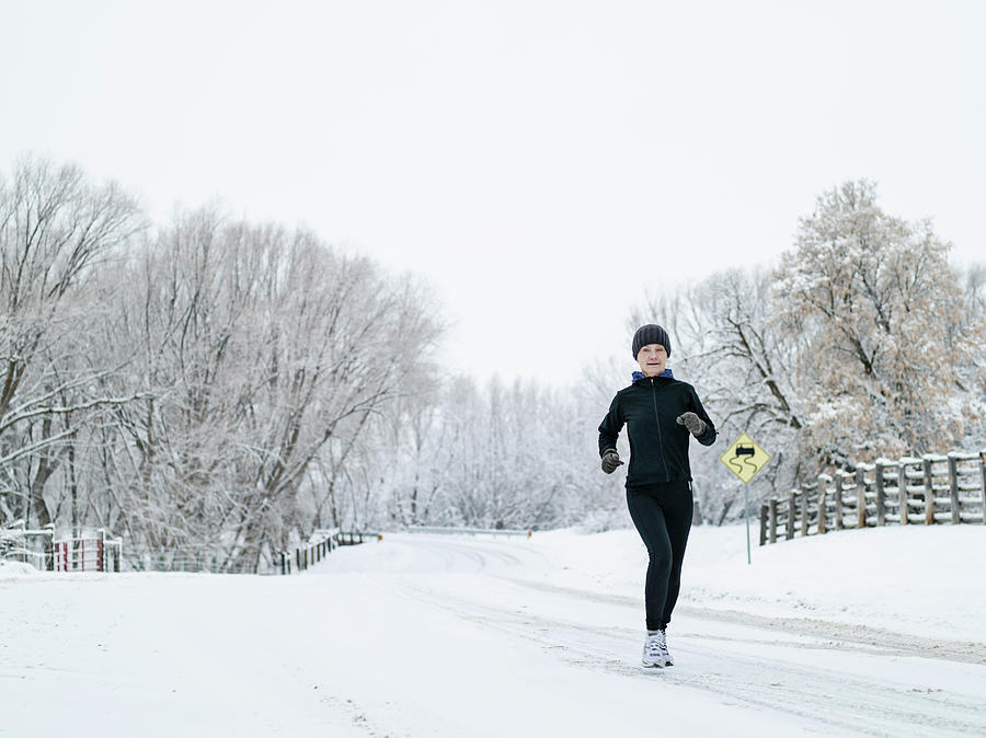 Woman Running On Country Road In Winter Photograph by Tony Anderson