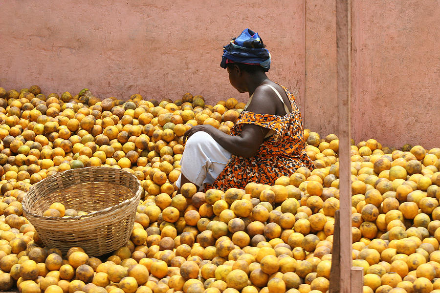 Woman selling oranges at market in Ghana Photograph by Nisa and Ulli Maier Photography
