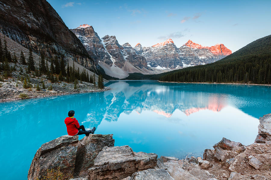 Woman sitting near Moraine lake, Banff, Canada Photograph by Matteo Colombo