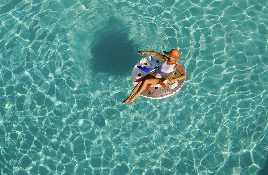 Woman Sitting On Float In Swimming Pool Photograph by Vintage Images