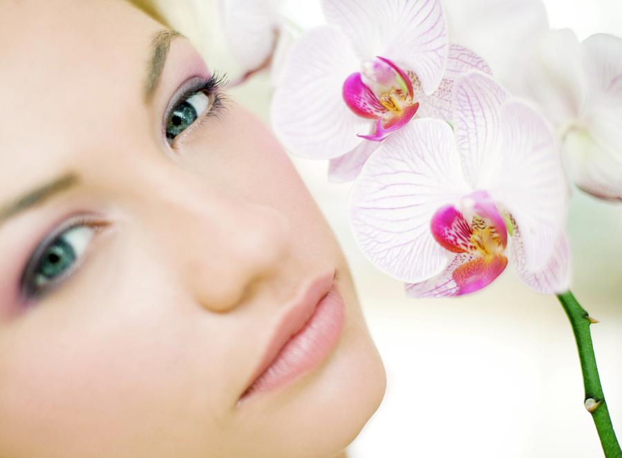Woman Smelling Orchid Flowers Photograph by Ian Hooton/science Photo Library