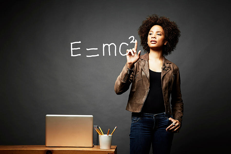 Woman solving mathematical equation Photograph by Jpm