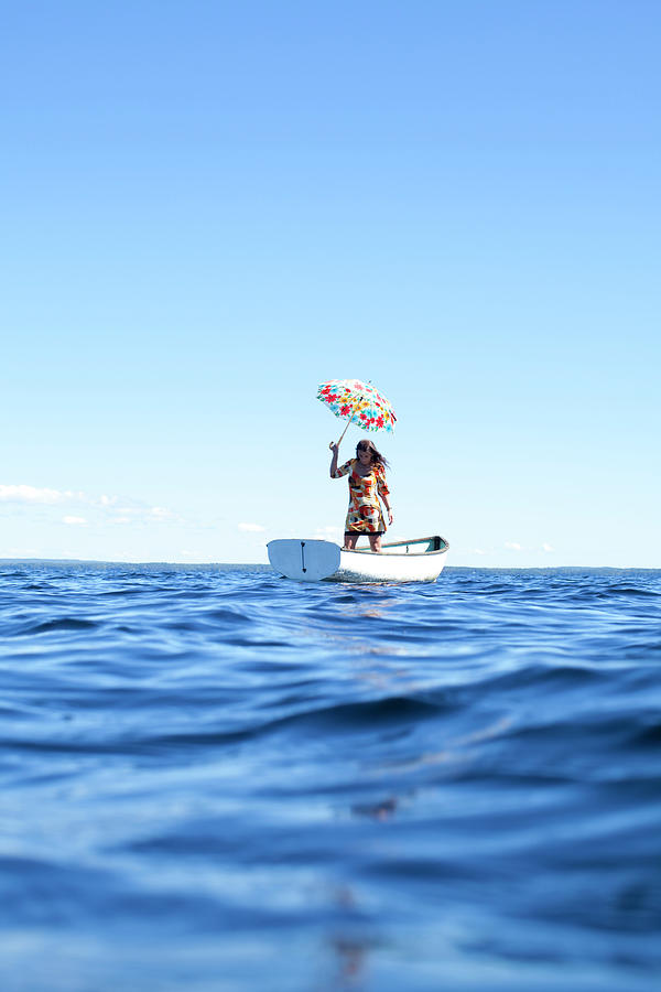 Woman Standing In A Small Rowboat Photograph by Woods Wheatcroft - Fine ...