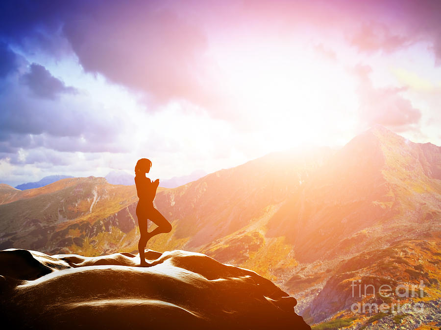 Woman standing in tree yoga position meditating in mountains at sunset Photograph by Michal Bednarek