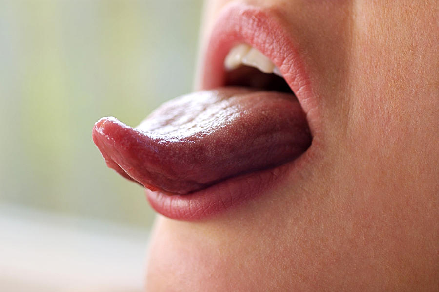 Woman sticking out tongue Photograph by Thinkstock Images