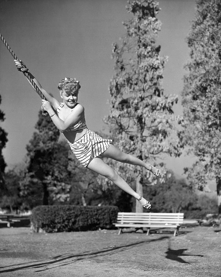 Woman Swinging On A Rope Photograph By Underwood Archives 