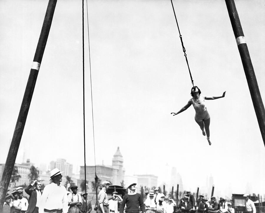 Woman Swings With Her Teeth Photograph by Underwood Archives - Fine Art ...