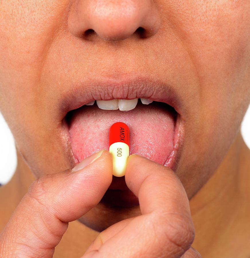 Woman Taking An Antibiotic Capsule Photograph by Cordelia Molloy/science Photo Library
