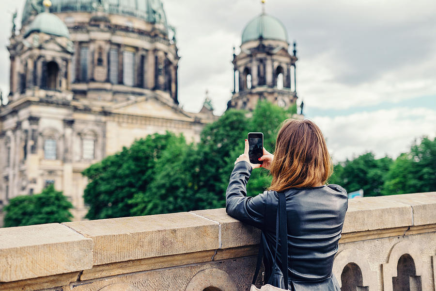 Woman taking photo of Berlin Cathedral with mobile phone Photograph by Xsandra
