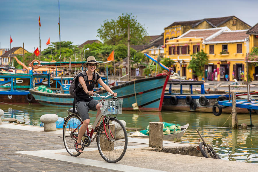 Woman Tourist Cycling in Hoi An City, Vietnam Photograph by Onfokus