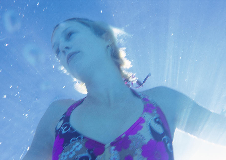 Woman underwater, low angle view Photograph by Sanna Lindberg