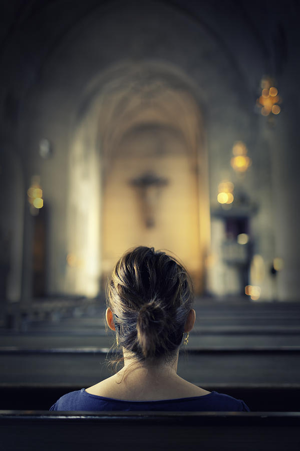 Woman visiting a christian church Photograph by LordRunar