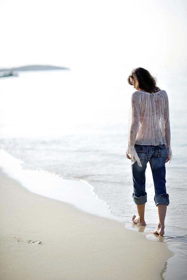 Summer Photograph - Woman Walking Along A Beach by Ian Hooton/science Photo Library