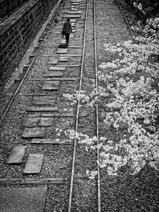 Pebbles Photograph - Woman walking along rail road track by John Wong