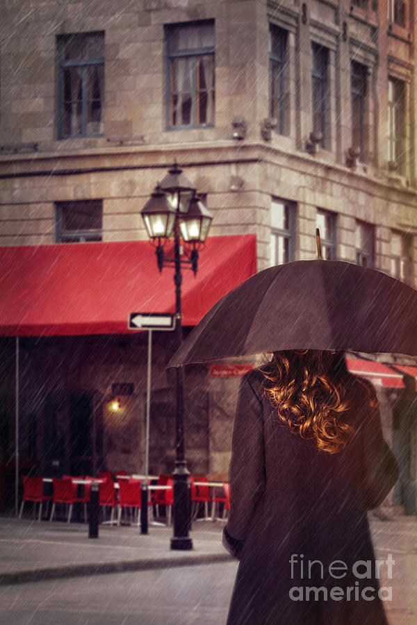 Woman walking with umbrella on city street in Montreal Photograph by Sandra Cunningham
