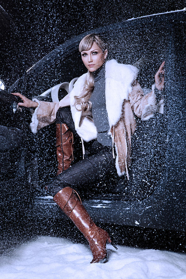 Woman Wearing Elegance Boots Sitting In Car At Winter Time Photograph by Lorado