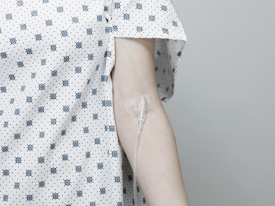 Woman Wearing Hospital Gown with Intravenous Drip. Photograph by Ballyscanlon