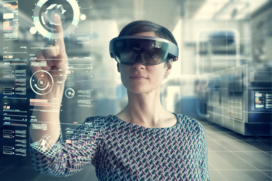 Woman wearing mixed reality smartglasses touching transparent screen Photograph by Westend61