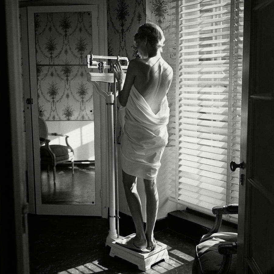 Woman Weighing Herself Photograph by Frances McLaughlin-Gill