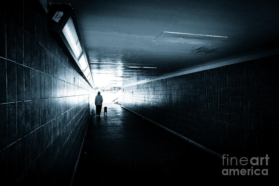Woman with dog walking through ols tiled underpass. Photograph by Peter Noyce