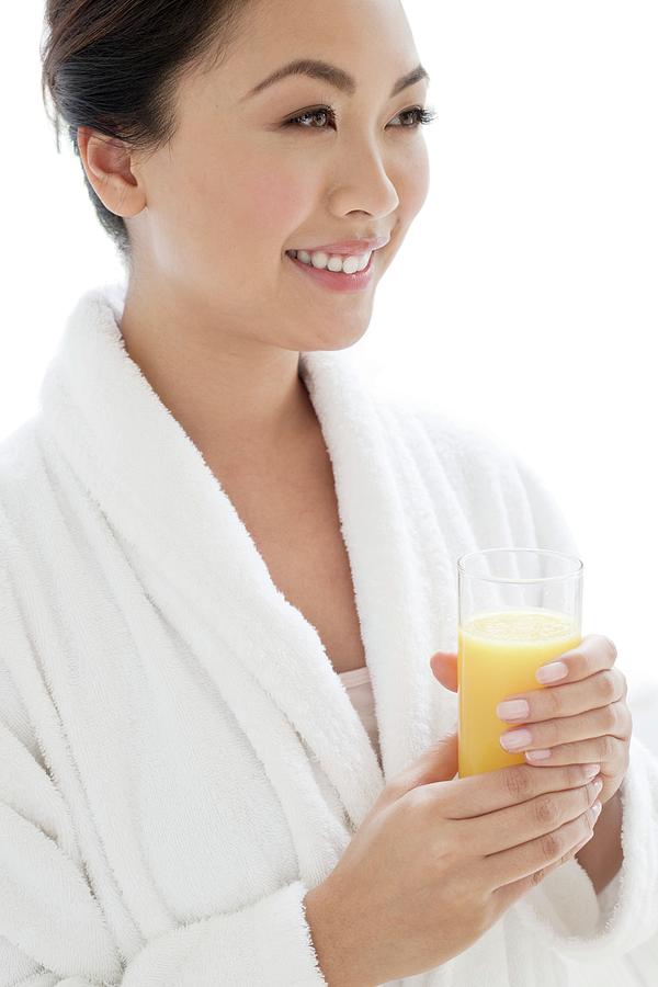 Woman With Glass Of Orange Juice Photograph by Ian Hooton/science Photo Library