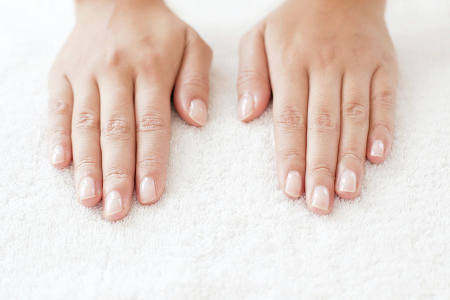 Woman With Hands Side By Side On White Towel by Science Photo Library