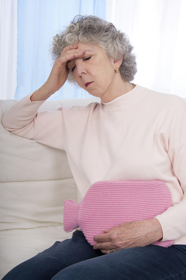 Woman With Hot Water Bottle Photograph by Lea Paterson/science Photo