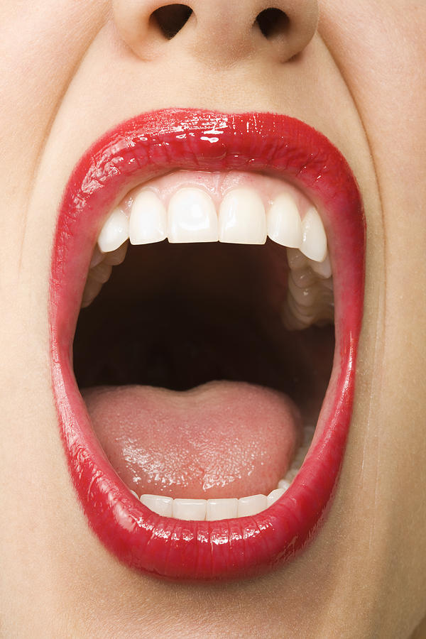 Woman with mouth open wide, close-up Photograph by Pando Hall