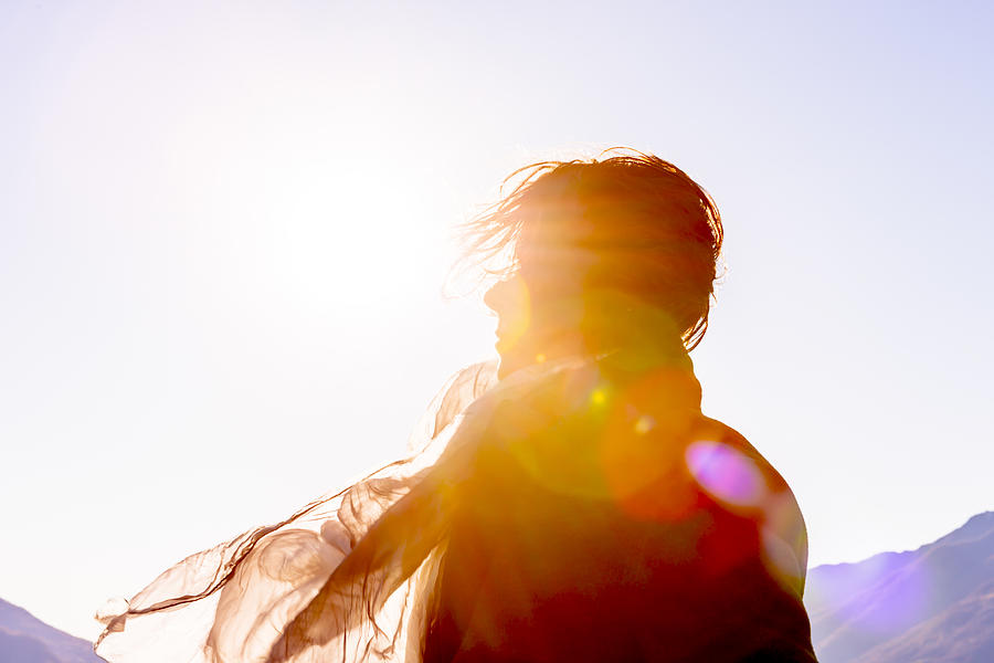 Woman with Moving Hair and Scarf in Sunlight in a Windy Day Photograph by Mats Silvan