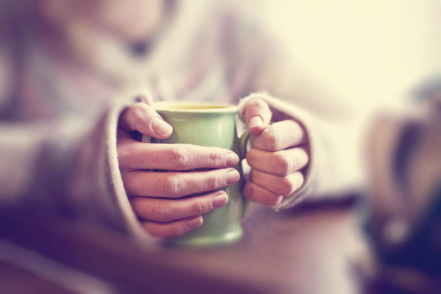Woman with mug of tea Photograph by Sally Anscombe