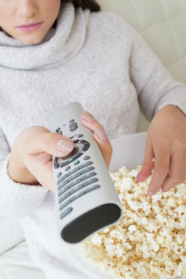 Woman With Tv Remote Eating Popcorn Photograph by Ian Hooton/science Photo Library