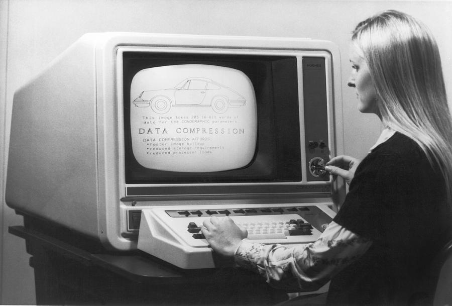 Black And White Photograph - Woman Working At 1975 Monitor by Underwood Archives