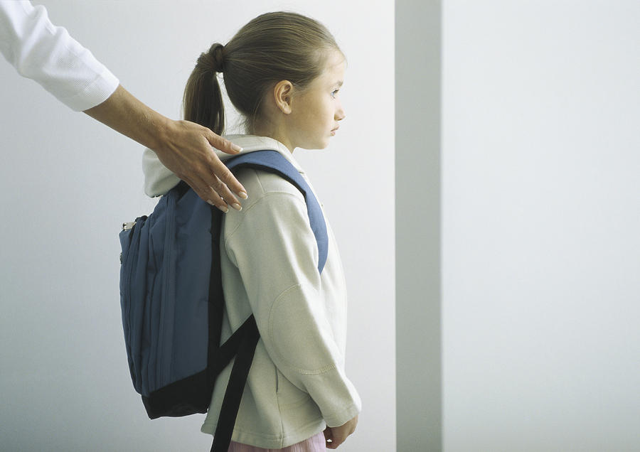 Womans hand on shoulder of girl with backpack Photograph by Sigrid Olsson