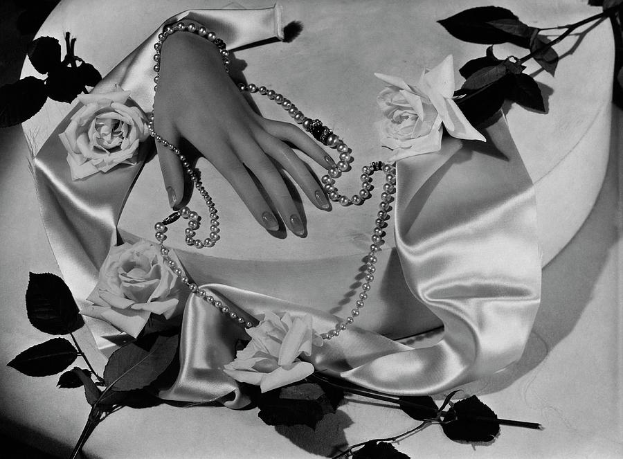 Womans Hand With A Pearl Necklace Photograph by Horst P. Horst