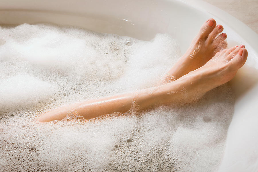 Womans Legs & Feet in Bubble Bath Photograph by Stevecoleimages