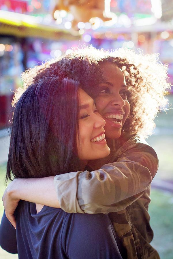 Outdoors Photograph - Women Hugging And Laughing In Sunlight by Science Photo Library