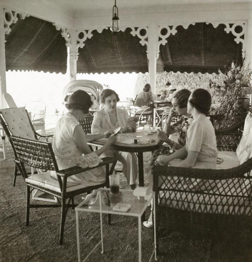 Women Playing A Card Game Photograph by John Rawlings