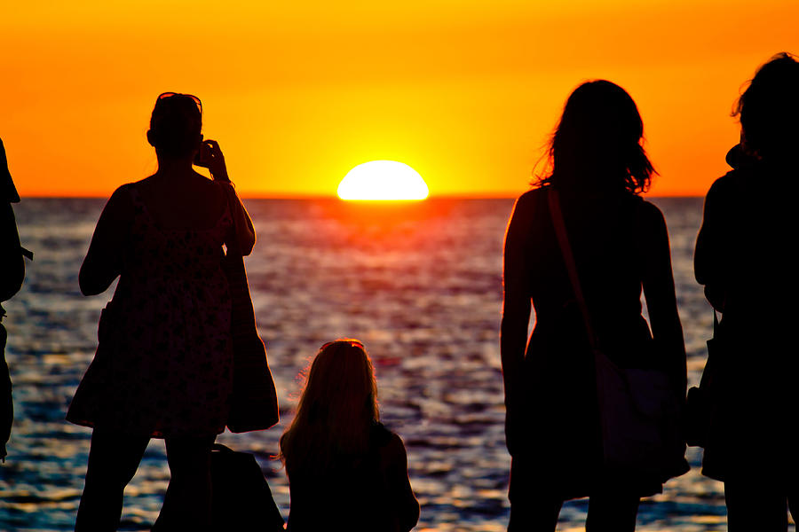 Women silhouette watching sunset on sea coast Photograph by Brch Photography
