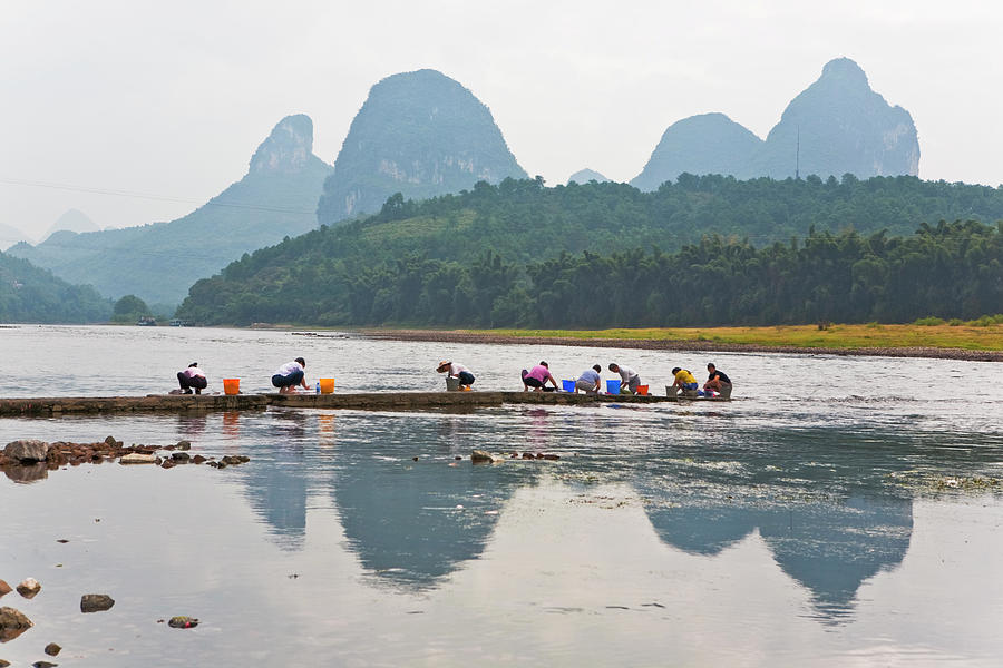 Women Washing Clothes By Li River With Photograph by Merten Snijders
