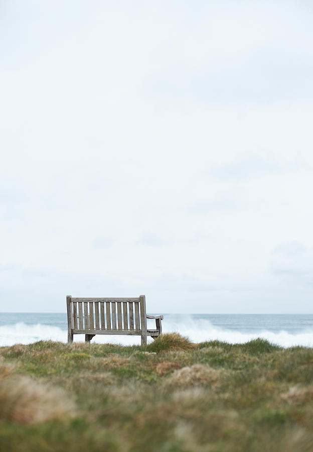 Wooden Bench On Uk Coastline Photograph by Dougal Waters