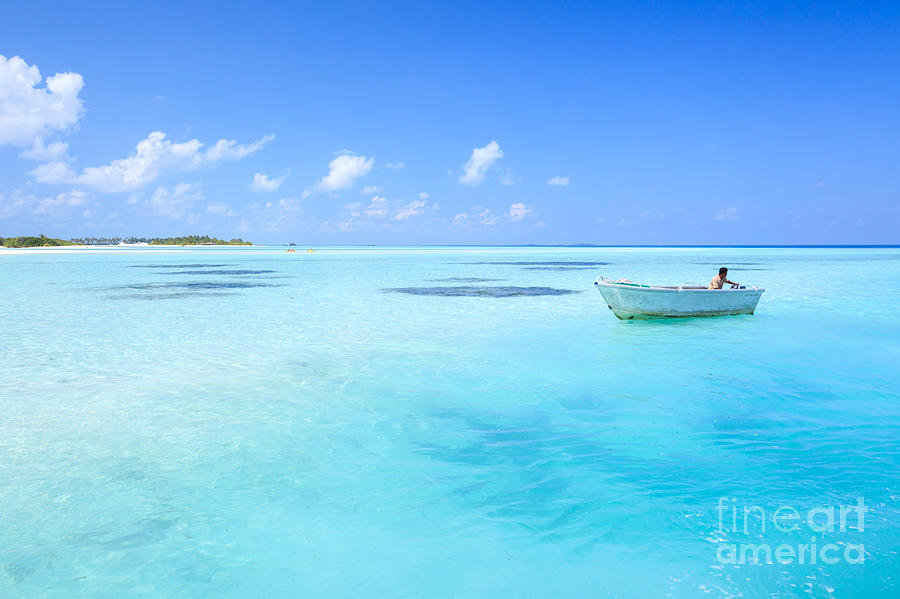 Wooden fisherman boat in the blue ocean Maldives Photograph by Matteo Colombo